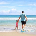 Dad walk on beach w daughter
